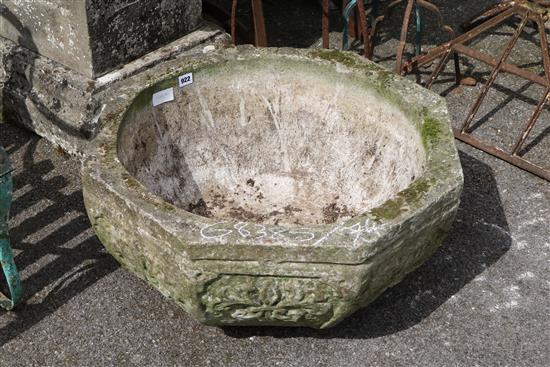 An octagonal reconstituted stone garden tub